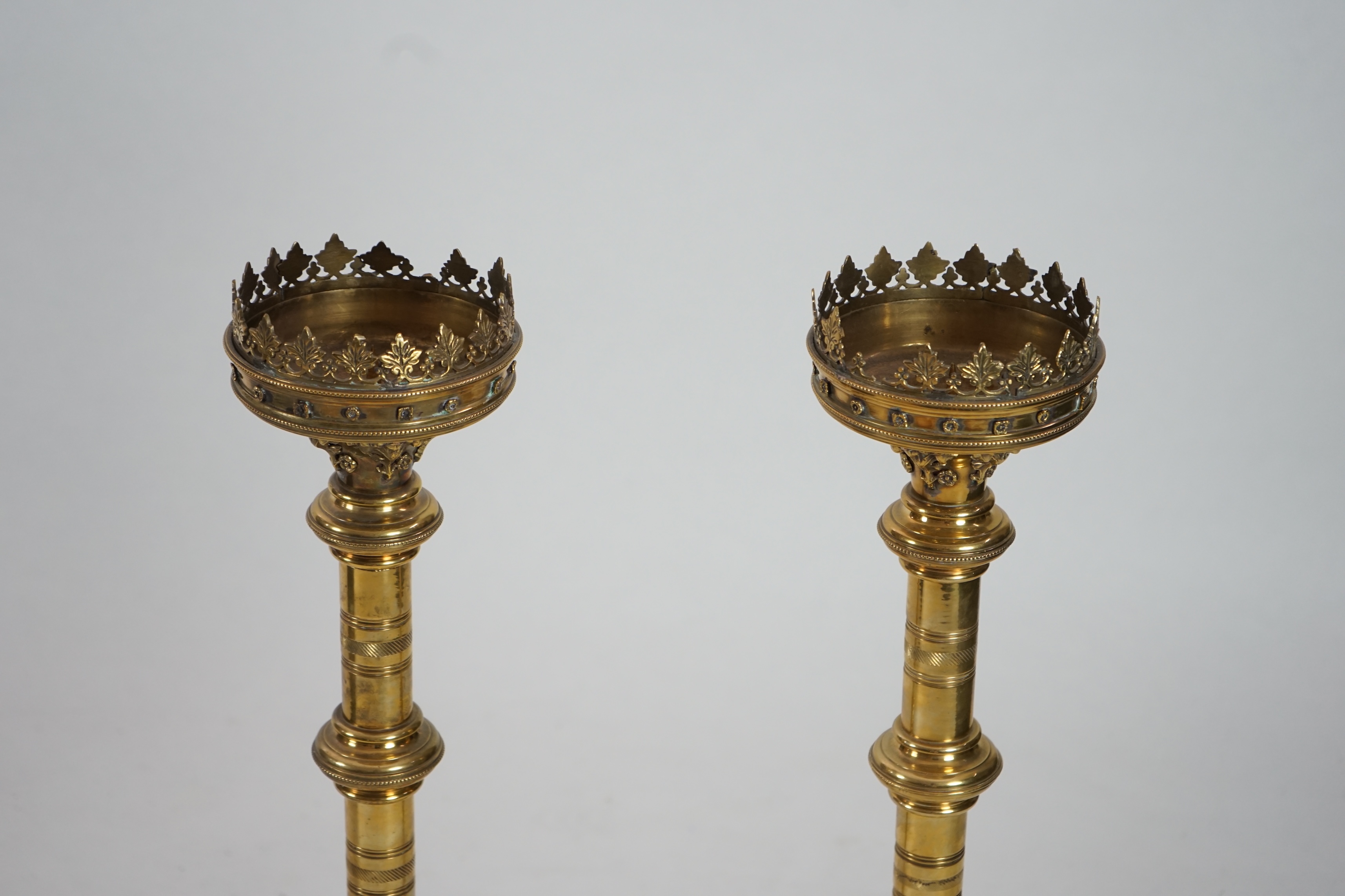 A pair of Victorian Gothic brass altar sticks